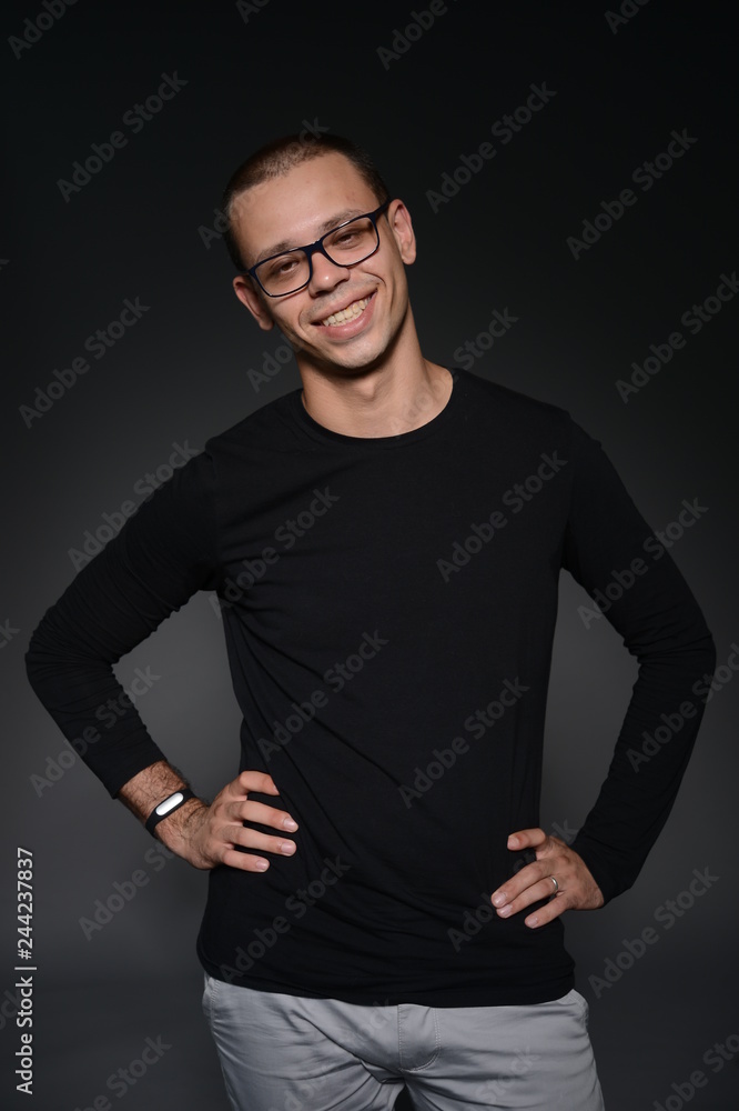 a man in a black jacket shows emotions in the Studio on a black background a man in a black jacket shows emotions in the Studio on a black background
