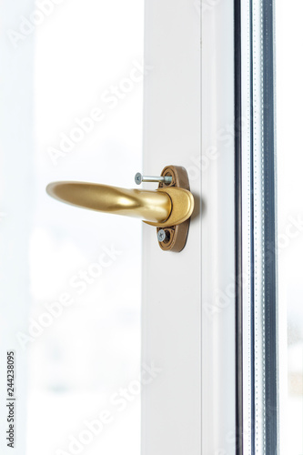 handle to open the sash in the window. Color is gold. screw cover open