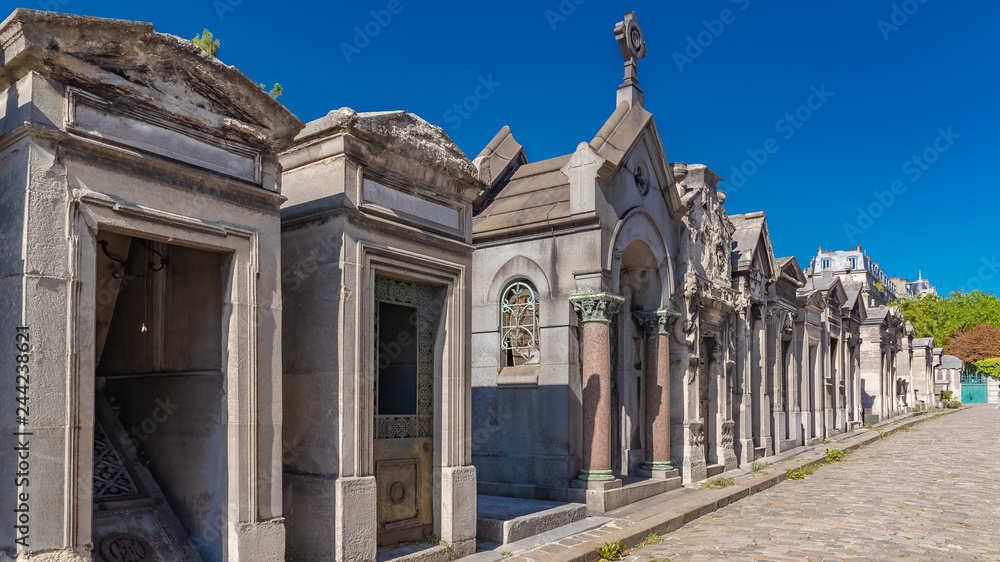 Paris, Montmartre cemetery, graves in the alley, sunny day