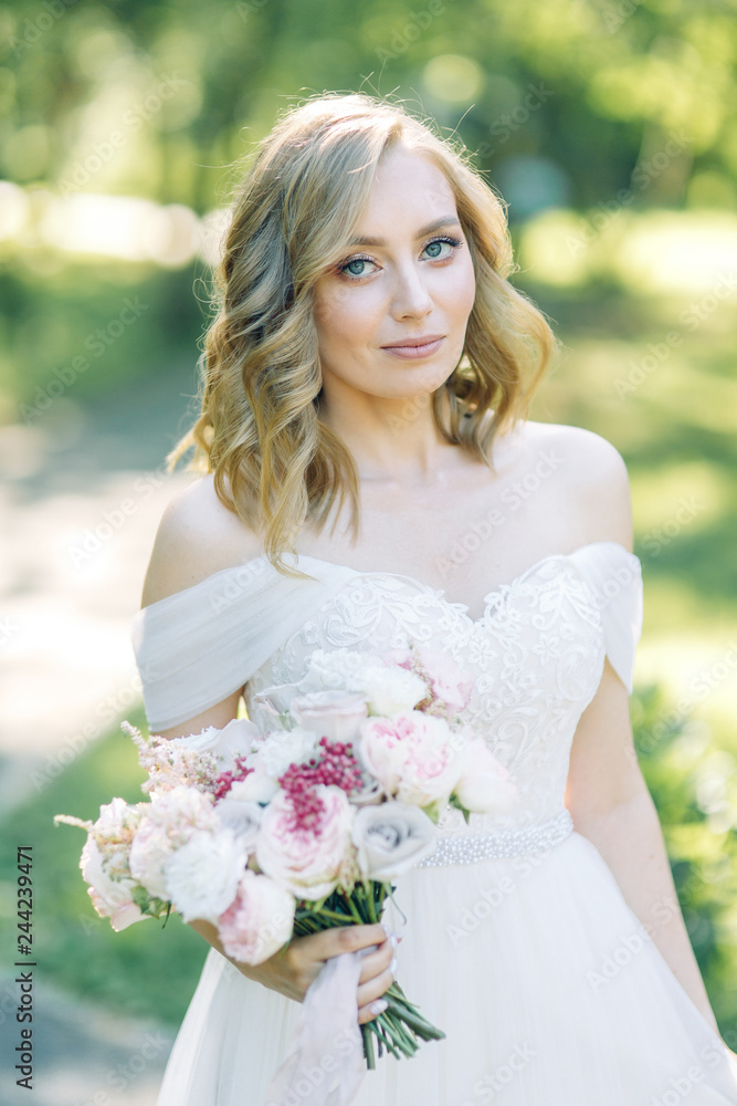The bride in a white dress in nature in the Park. Photo shoot with a bouquet in the style of fine art. The bride in a white dress in nature in the Park. Photo shoot with a bouquet in the style of fine art.