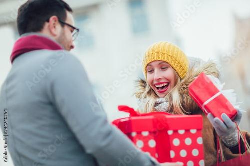Man giving woman a surprise gift