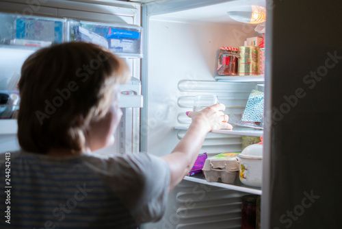woman driink water from fridge at midnight b