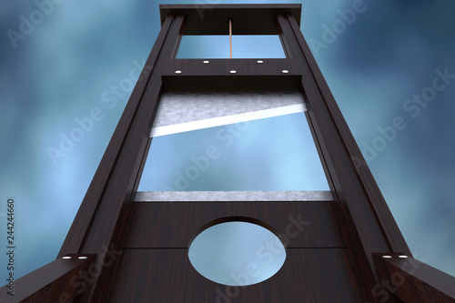Fotografija Guillotine instrument for inflicting capital punishment by decapitation and dramatic cloud background