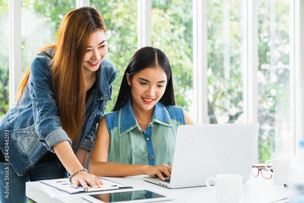Business meeting. Young asian coworker woman team making business discussion in modern home office. Teamwork people concept. Casual account manager crew working new startup project on laptop Business meeting. Young asian coworker woman team making business discussion in modern home office. Teamwork people concept. Casual account manager crew working new startup project on laptop