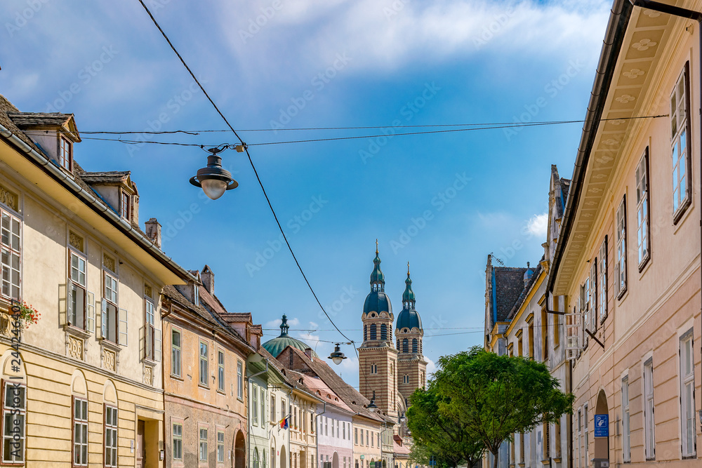 Obraz premium Sibiu, Romania - Beautiful street with Holy Trinity Cathedral on a sunny summer day in Sibiu, Romania