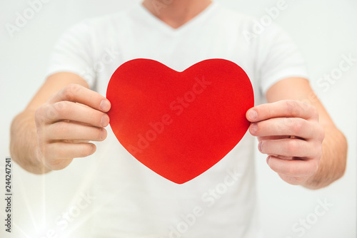 hands holding big paper red heart