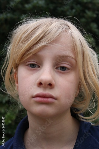 Portrait of a pale unhappy tired listless young blond girl
