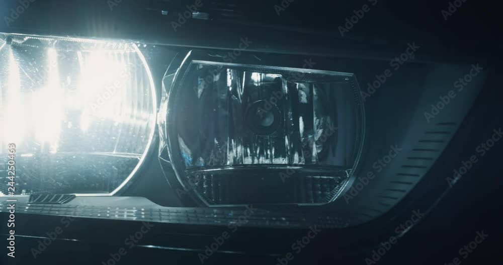 Close up of details of switched on headlights of anonymous prestigious luxury modern car. Shot in 8K. Concept of passion for driving cars and engines, car dealerships, used cars,luxury cars, auto dial Close up of details of switched on headlights of anonymous prestigious luxury modern car. Shot in 8K. Concept of passion for driving cars and engines, car dealerships, used cars,luxury cars, auto dial