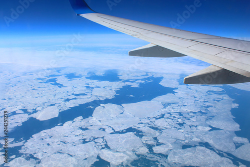 Flight on the plane over the sea. Top view from the window. Background. Landscape.
