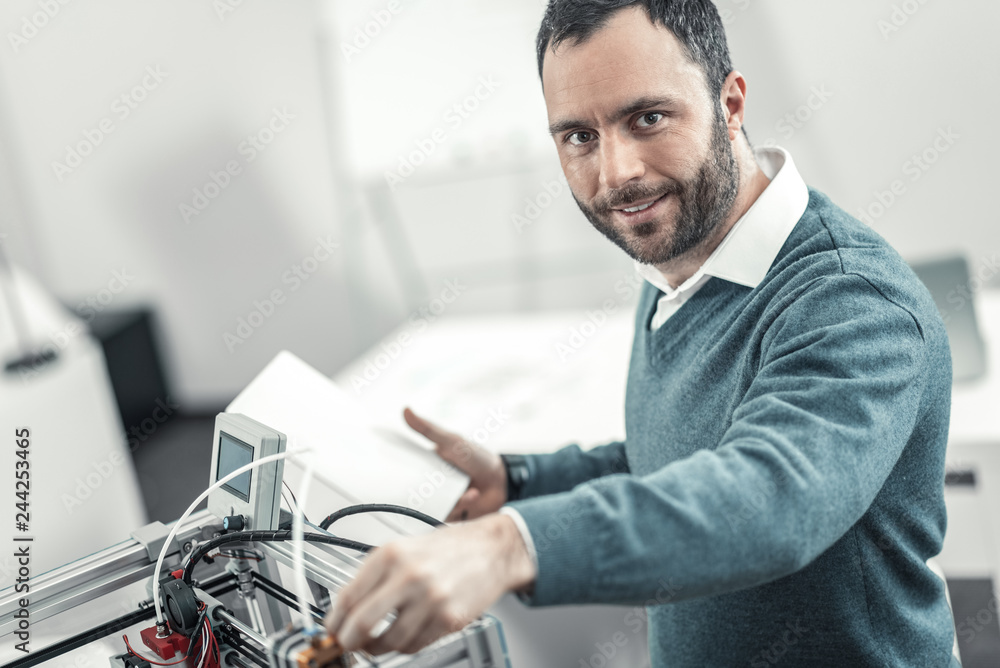 Delighted smart adult technician checking 3d printer Stock Photo | Adobe  Stock