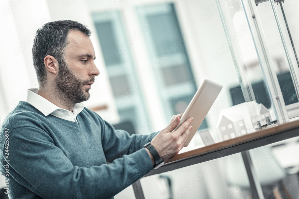 Fototapeta premium Serious skilled man being in the office
