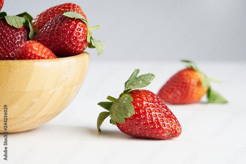 Fresh perfect berries red strawberries in a wooden plate on white, Concept of healthy eat food and nutrition.. Fresh perfect berries red strawberries in a wooden plate on white, Concept of healthy eat food and nutrition..