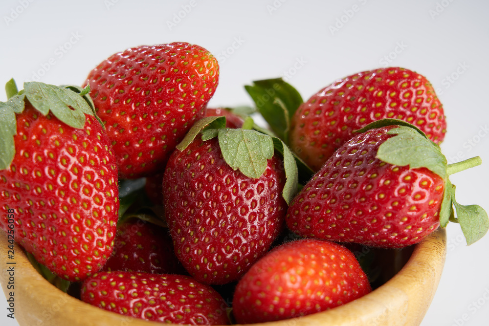 Fresh perfect berries red strawberries in a wooden plate on white, Concept of healthy eat food and nutrition.. Fresh perfect berries red strawberries in a wooden plate on white, Concept of healthy eat food and nutrition..