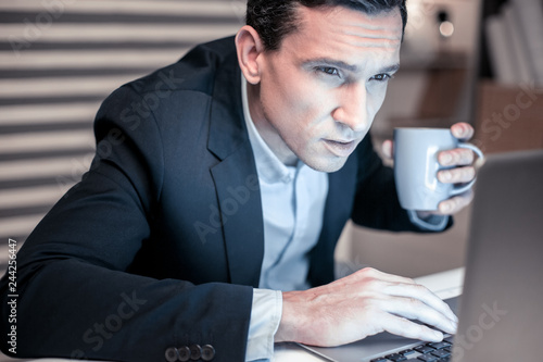 Nice handsome man focusing on his work