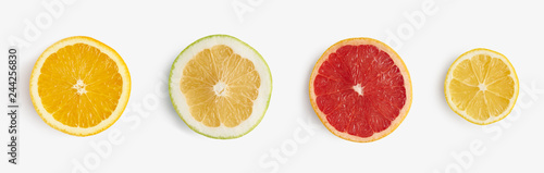 Fresh citrus fruits orange, lemon, grapefruit, pomelo half-sliced from above, pattern for layout. healthy food and nutrition.