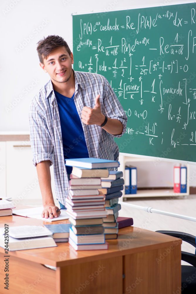 Young male student studying math at school Young male student studying math at school
