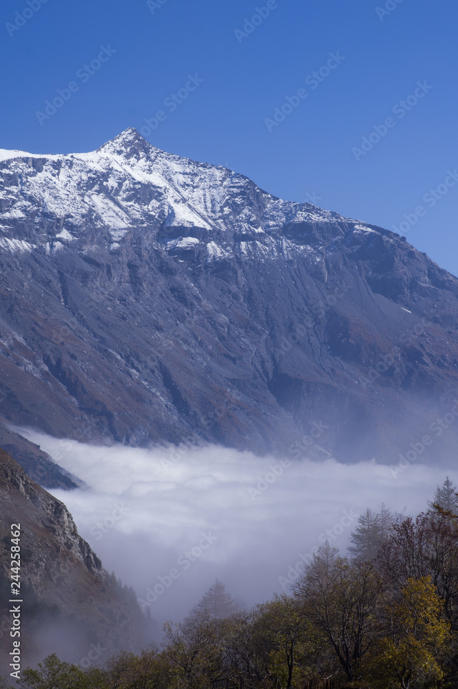 The clouds under the Rocciamelone Italy may look like a white river flowing among the mountains.