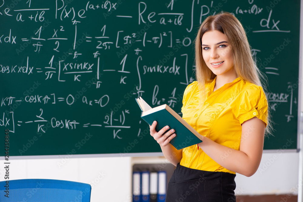 Young female student in front of the chalkboard