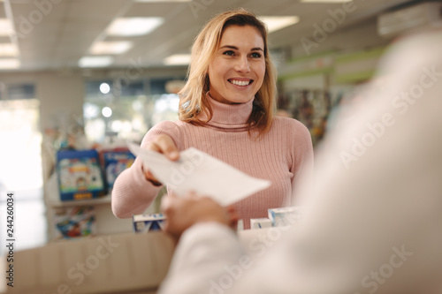 Tableau sur toile Customer giving a prescription to the chemist