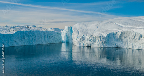 Iceberg aerial photo - giant icebergs in Disko Bay on greenland floating in Ilulissat icefjord from melting glacier Sermeq Kujalleq Glacier  aka Jakobhavns Glacier. Global warming and climate change