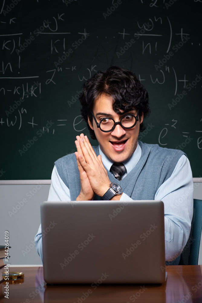 Young math teacher in front of chalkboard Young math teacher in front of chalkboard