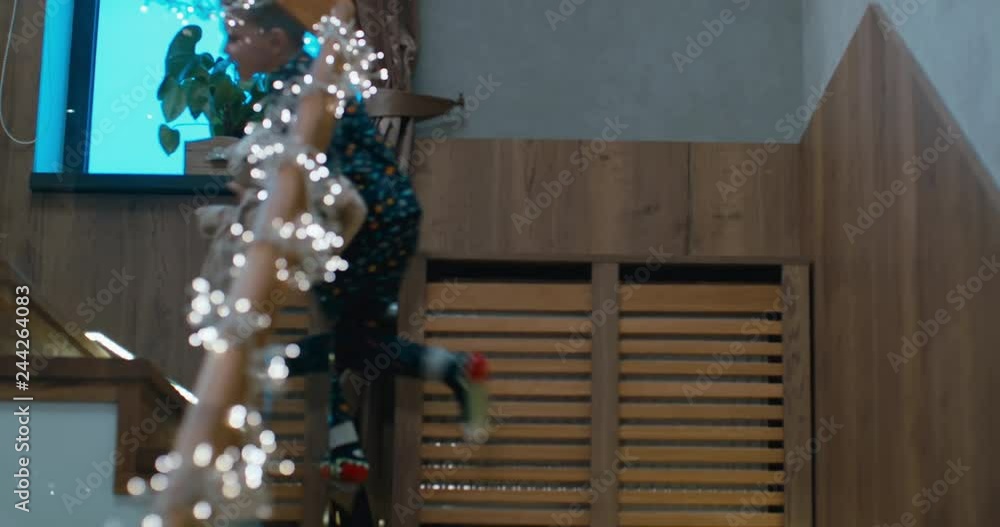 CU Cute little kid boy running upstairs in the evening, with pillow in hands. 4K UHD Blackmagic RAW CU Cute little kid boy running upstairs in the evening, with pillow in hands. 4K UHD Blackmagic RAW