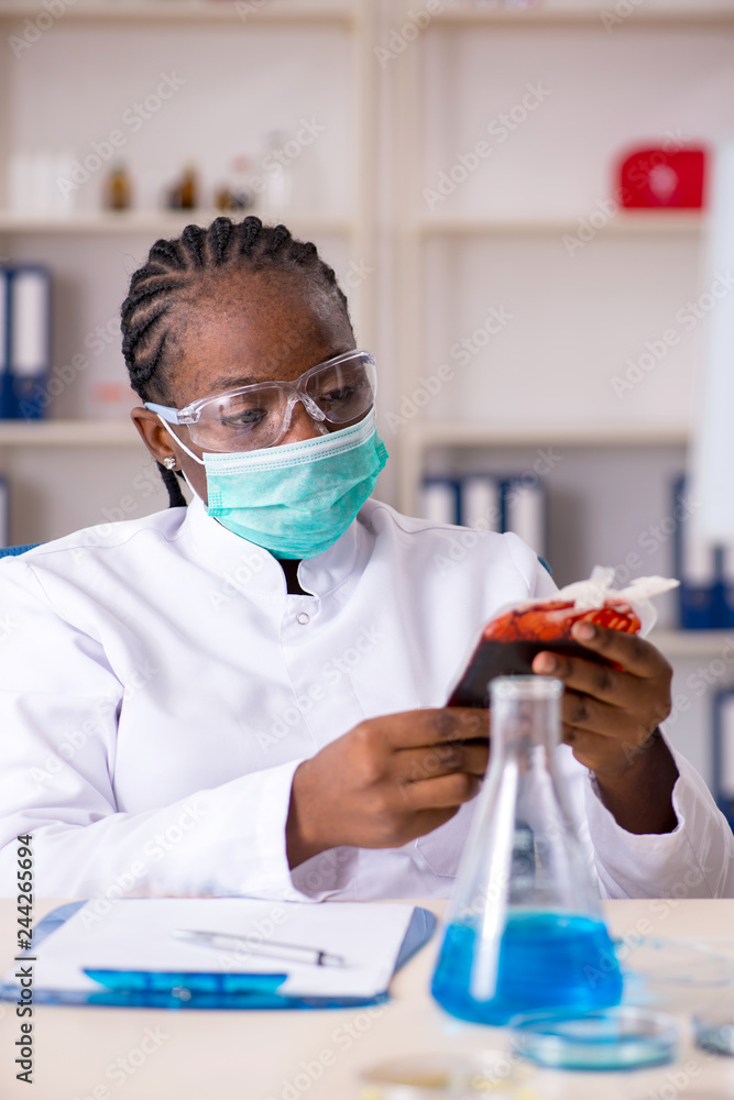 Young black chemist working in the lab Young black chemist working in the lab
