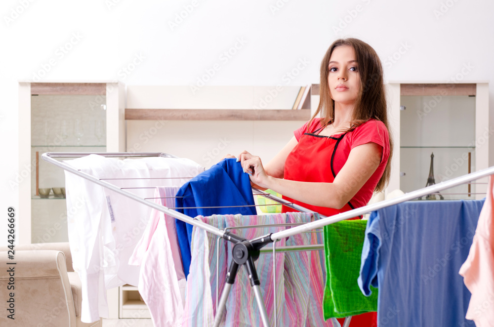 Young beautiful woman doing laundry at home Young beautiful woman doing laundry at home