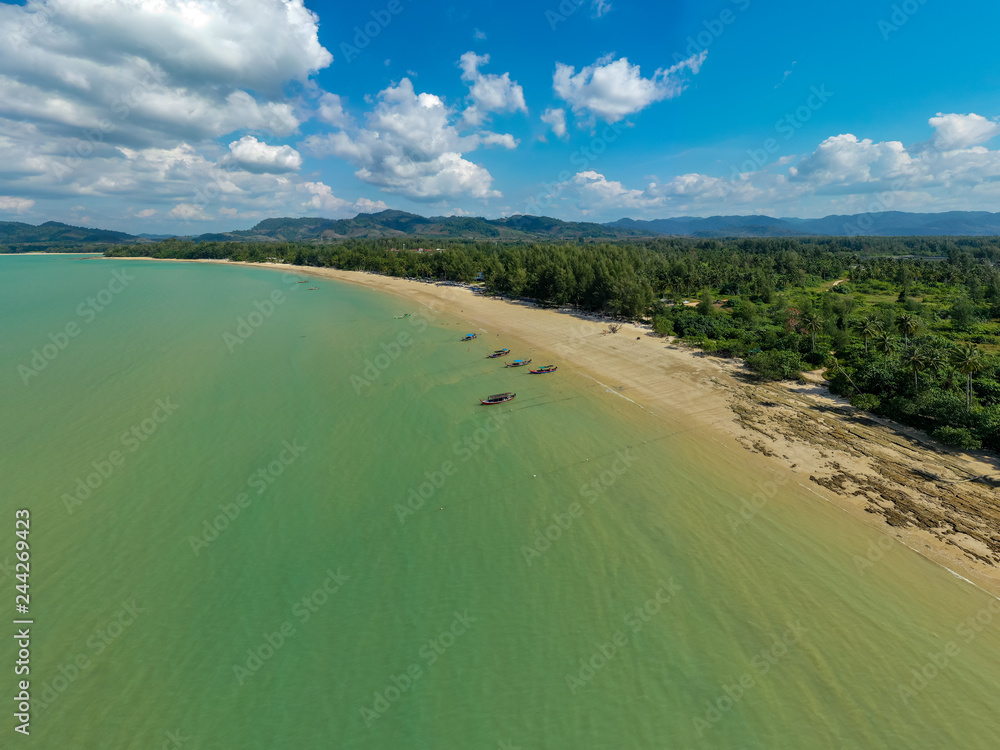 Aerial view of a quiet tropical sandy beach and shallow ocean (Coconut Beach, Pakarang Cape, Thailand)