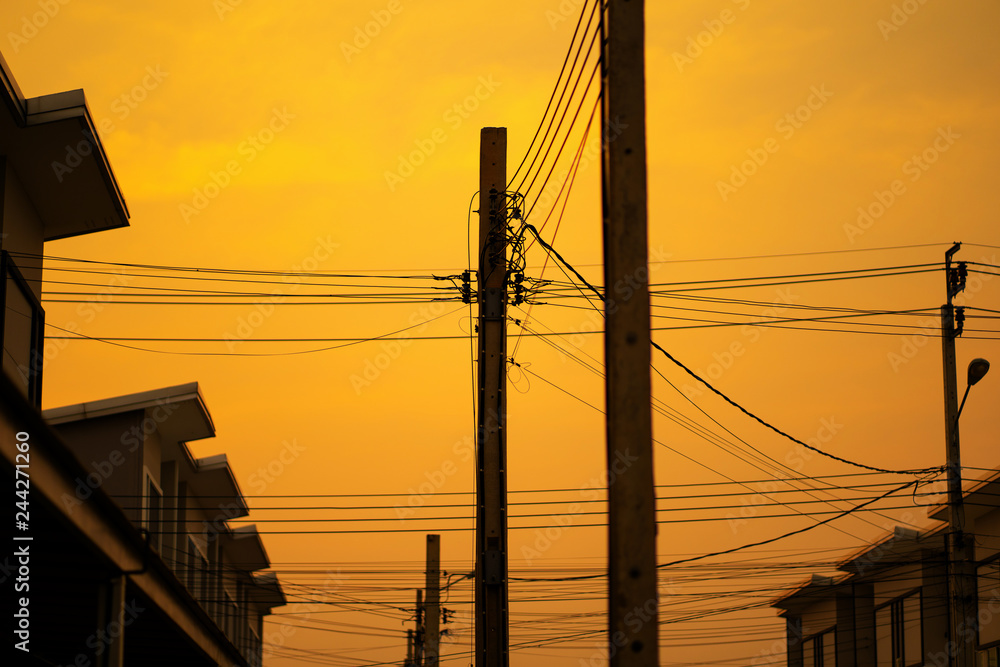 silhouette electric pole with townhome