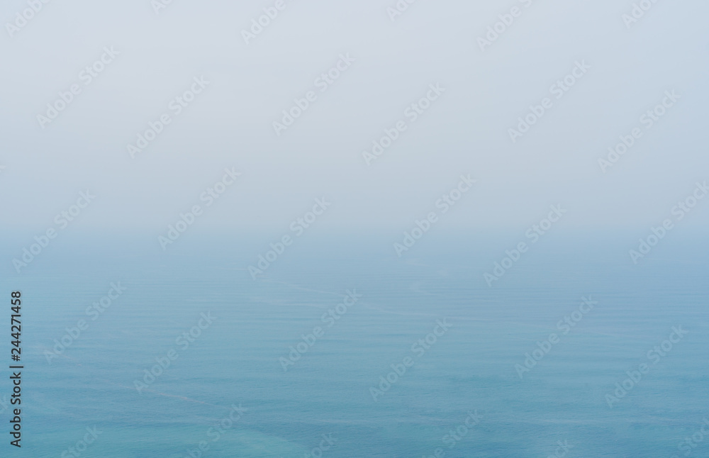 Blue sea with mist and overcast sky, mystery environment over ocean