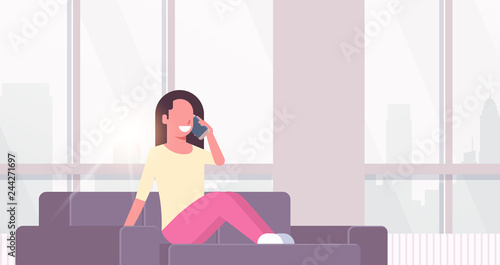 young woman phone calling happy girl sitting couch using smartphone communication concept modern living room interior cityscape background flat horizontal