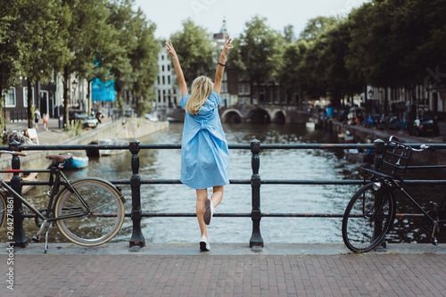 Photography girl in a blue dress on the bridge in Amsterdam