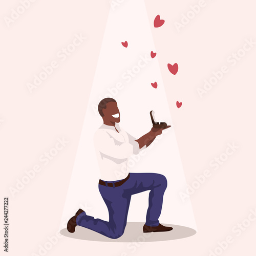 Man kneeling holding engagement ring proposing marry