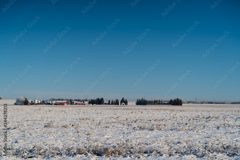 Farm house and silo's with snow covered fields