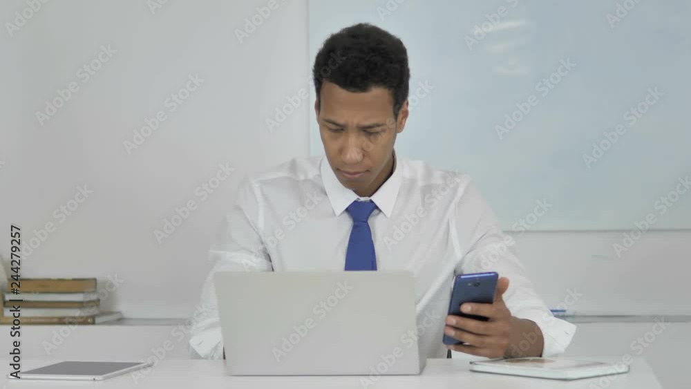 Afro-American Businessman Using Smartphone for Online Work Afro-American Businessman Using Smartphone for Online Work