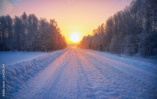 Sun over siberian rural empty road under the snow at morning time photo