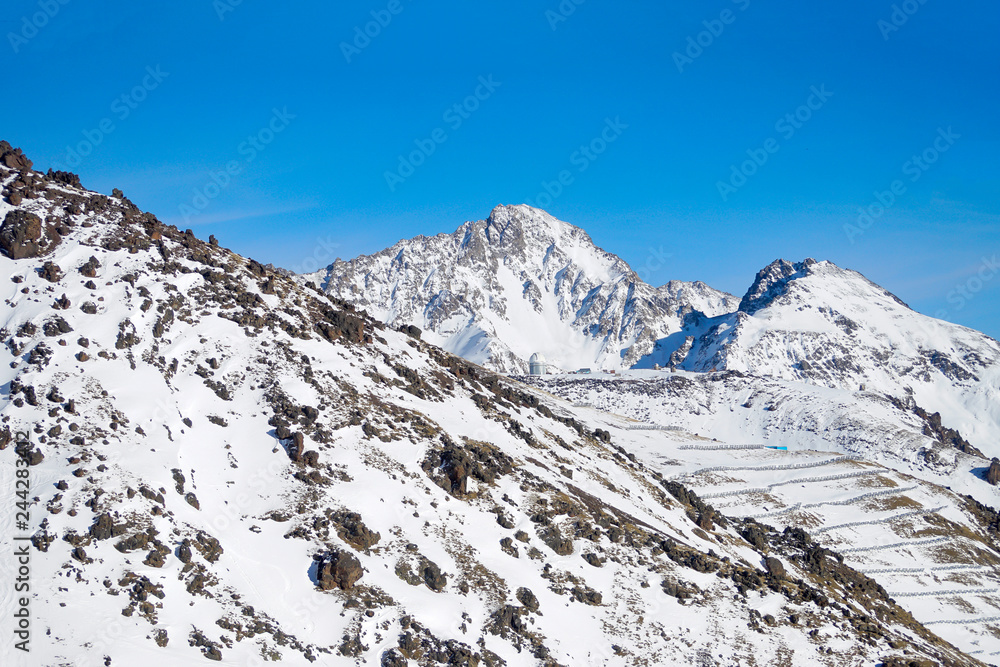 Snowboarding and skiing. The peaks of Elbrus. North Caucasus Russia..