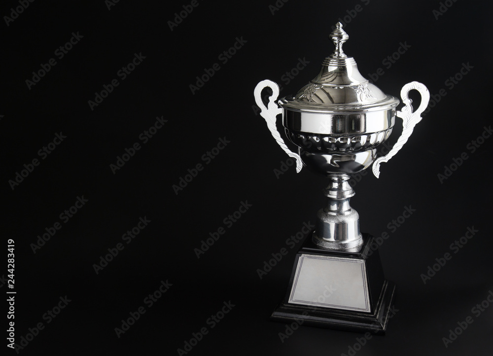 Silver trophy over black background. Winning awards with copy space for text and design. Silver trophy over black background. Winning awards with copy space for text and design.
