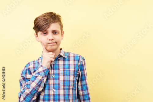 bored disinterested weariful indifferent unenthusiastic boy with tired face expression over yellow background, advertisement, banner or poster template, emotion, people reaction