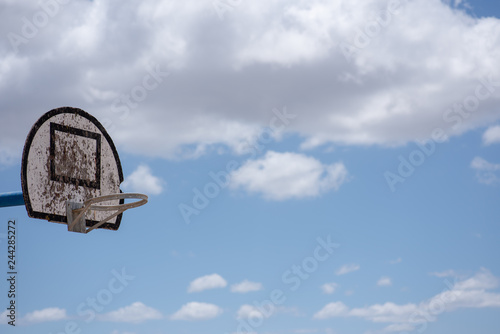 Basketball hoop with clear clouds in the background