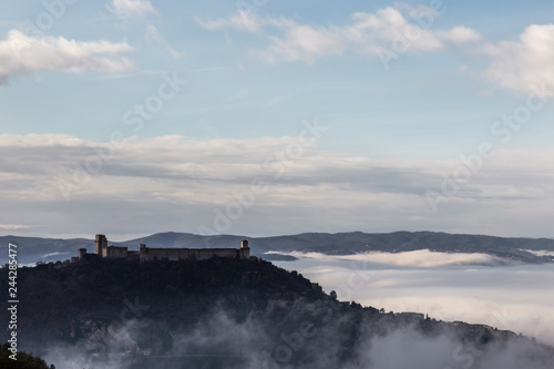 A view of Rocca Maggiore castle in Assisi (Umbria, Italy) in the middle of fog