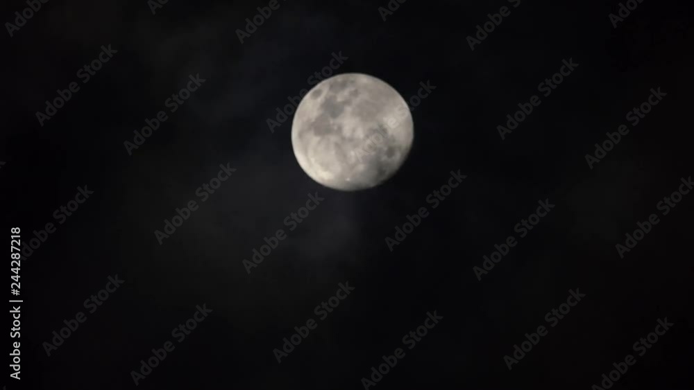 Full moon at night with clouds floating through Full moon at night with clouds floating through