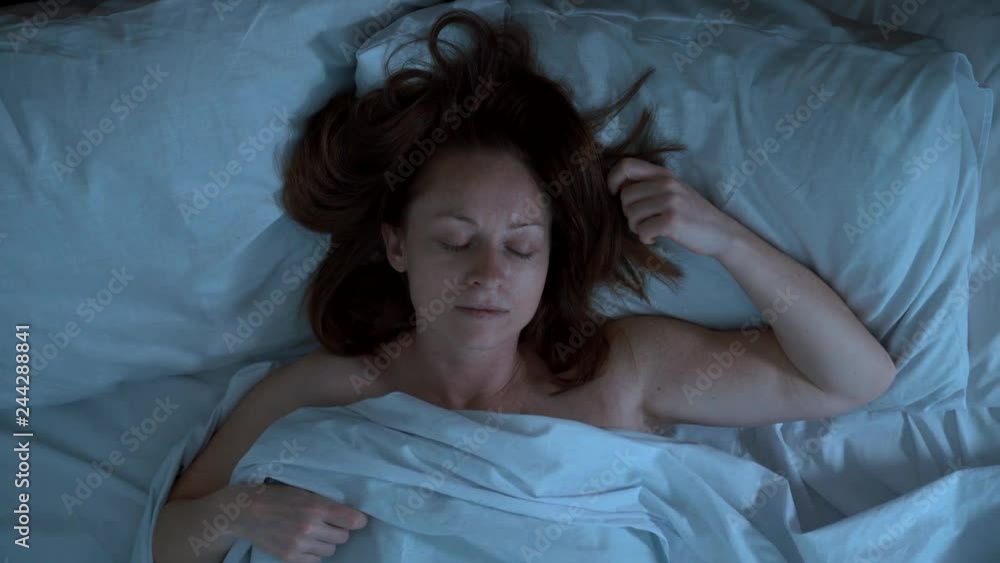 Someone pulls blanket with sleeping girl at night.
Someone pulls blanket with sleeping girl at night.