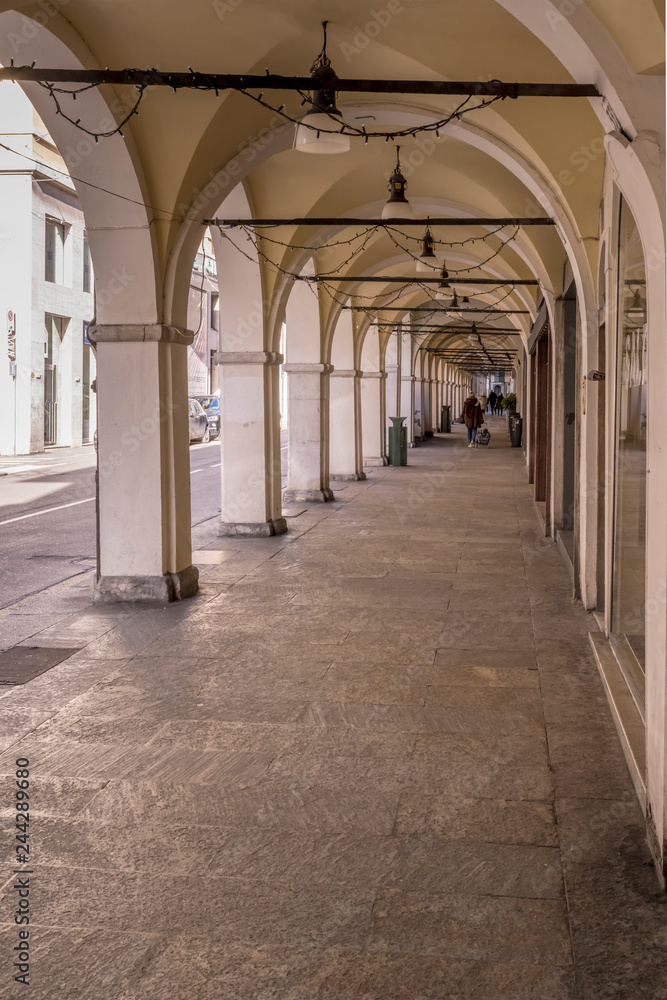 historical covered walkway in town center, Brescia, Italy