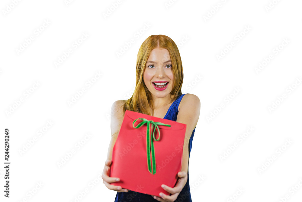 A beautiful young red-haired girl in an evening dress who holds a gift in a red box with both hands intending to present it to someone and looks into the camera while smiling at an isolated background A beautiful young red-haired girl in an evening dress who holds a gift in a red box with both hands intending to present it to someone and looks into the camera while smiling at an isolated background