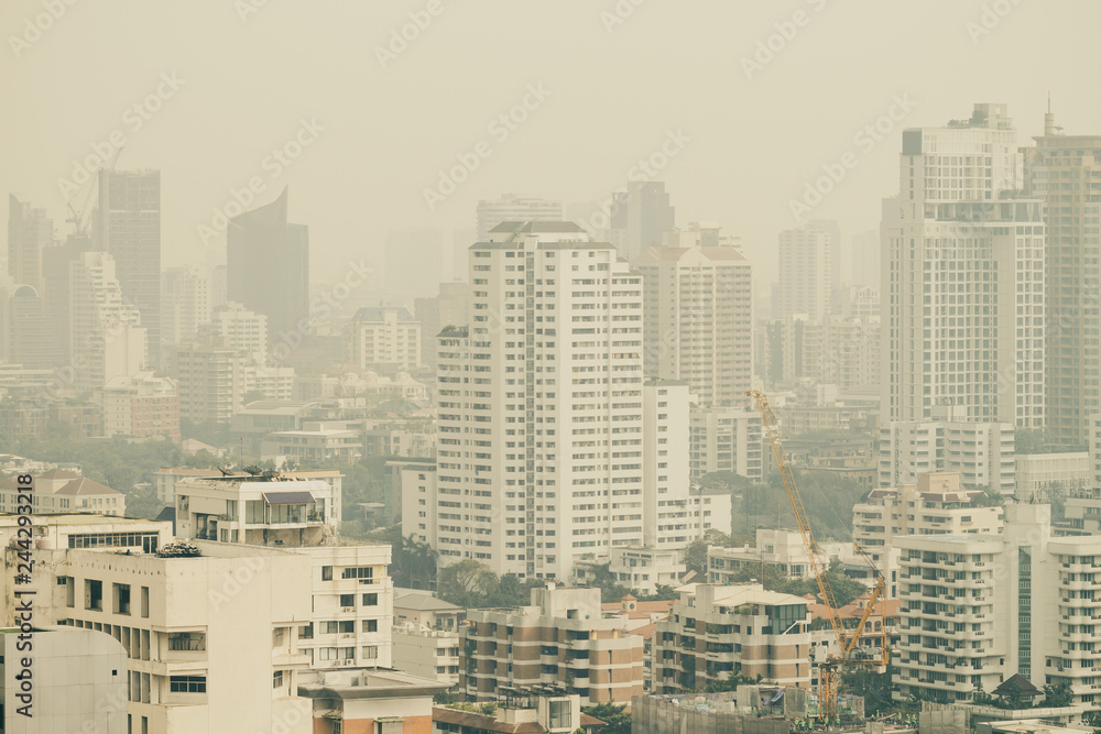 cityscape of high rise buildings in poor weather morning, haze of pollution covers city cityscape of high rise buildings in poor weather morning, haze of pollution covers city