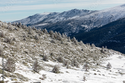 Way of ascent to the lagoons of Pe  alara in the mountain range of Madrid covered by snow.