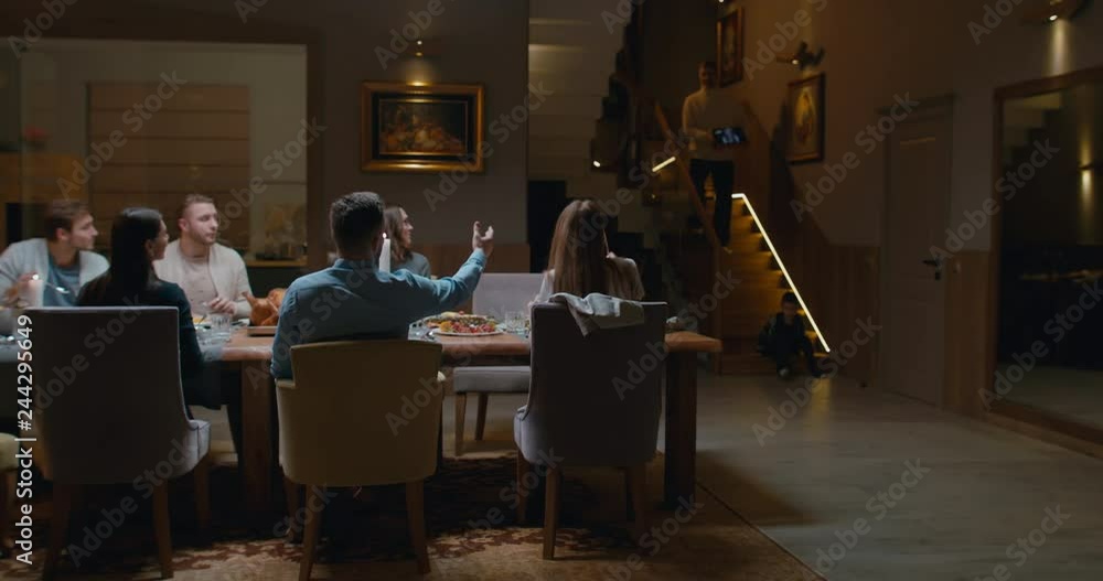 Senior man grandfather having a video call with his daughter during thanksgiving dinner, happy family greeting a remote guest. 4K UHD 60 FPS SLOW MOTION Blackmagic RAW Senior man grandfather having a video call with his daughter during thanksgiving dinner, happy family greeting a remote guest. 4K UHD 60 FPS SLOW MOTION Blackmagic RAW