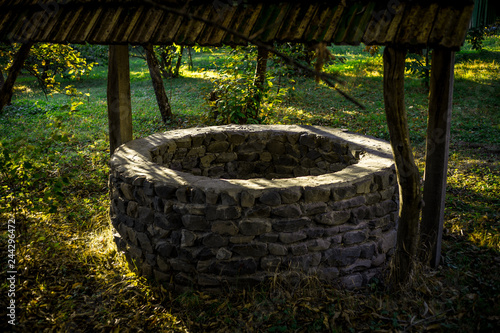 Fotografie Abandoned well in the forest